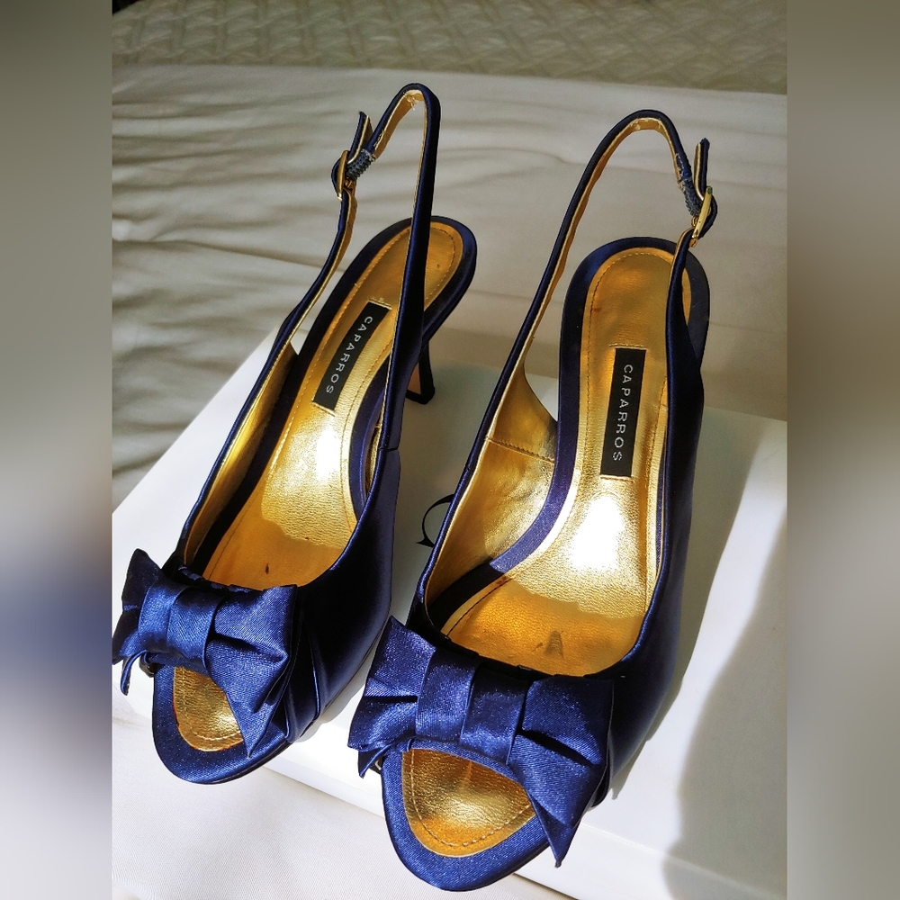 Pumps: Navy blue slingback peep toe pump with bow feature.